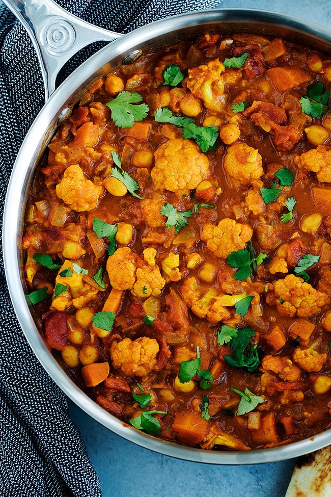 Vegetarian Tikka Masala That Is Made With Cauliflower, Chickpeas, And A Rich Creamy Tomato Sauce. Serve With Basmati Rice And Naan Bread For A Delicious Indian Dinner At Home. #vegetarian #vegan #veganrecipe #healthyrecipe #glutenfree #cauliflower #chickpeas #dinner #dinnerrecipe #tikkamasala #Indian Skillet Vegetarian Tikka Masala