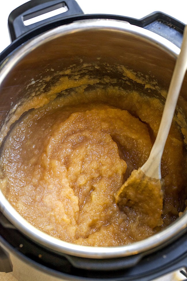 applesauce in instant pot with wooden spoon.