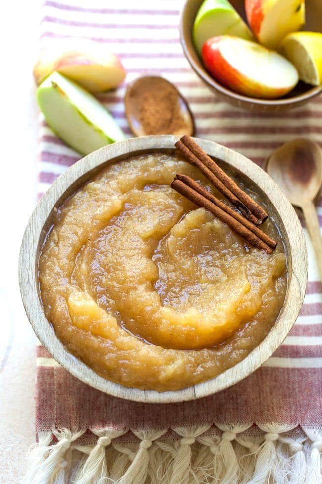 applesauce with cinnamon sticks in bowl. 