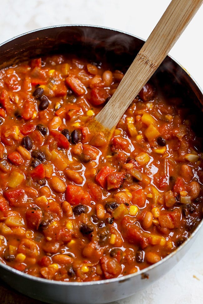 pumpkin chili in pot with wooden spoon.