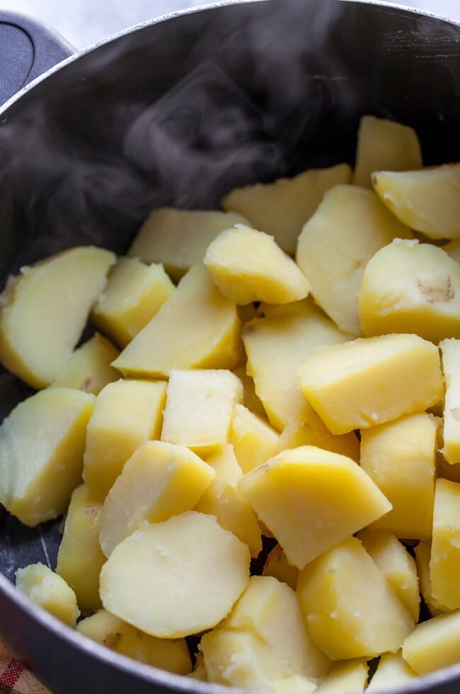 potatoes cooking in pot to make garlic mashed potatoes.