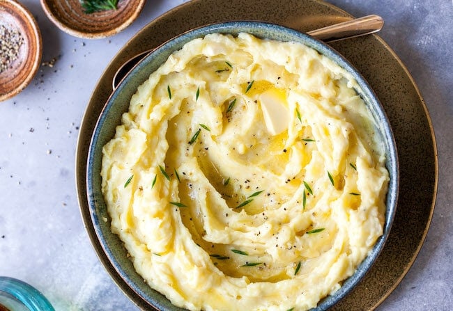 Easy Garlic Mashed Potatoes with chives in bowl.