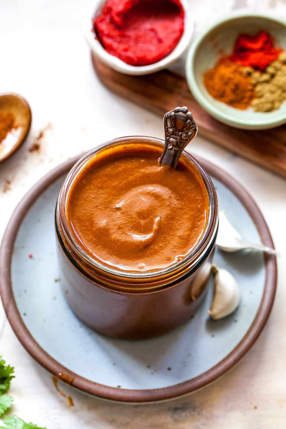 homemade enchilada sauce in jar with spoon. 