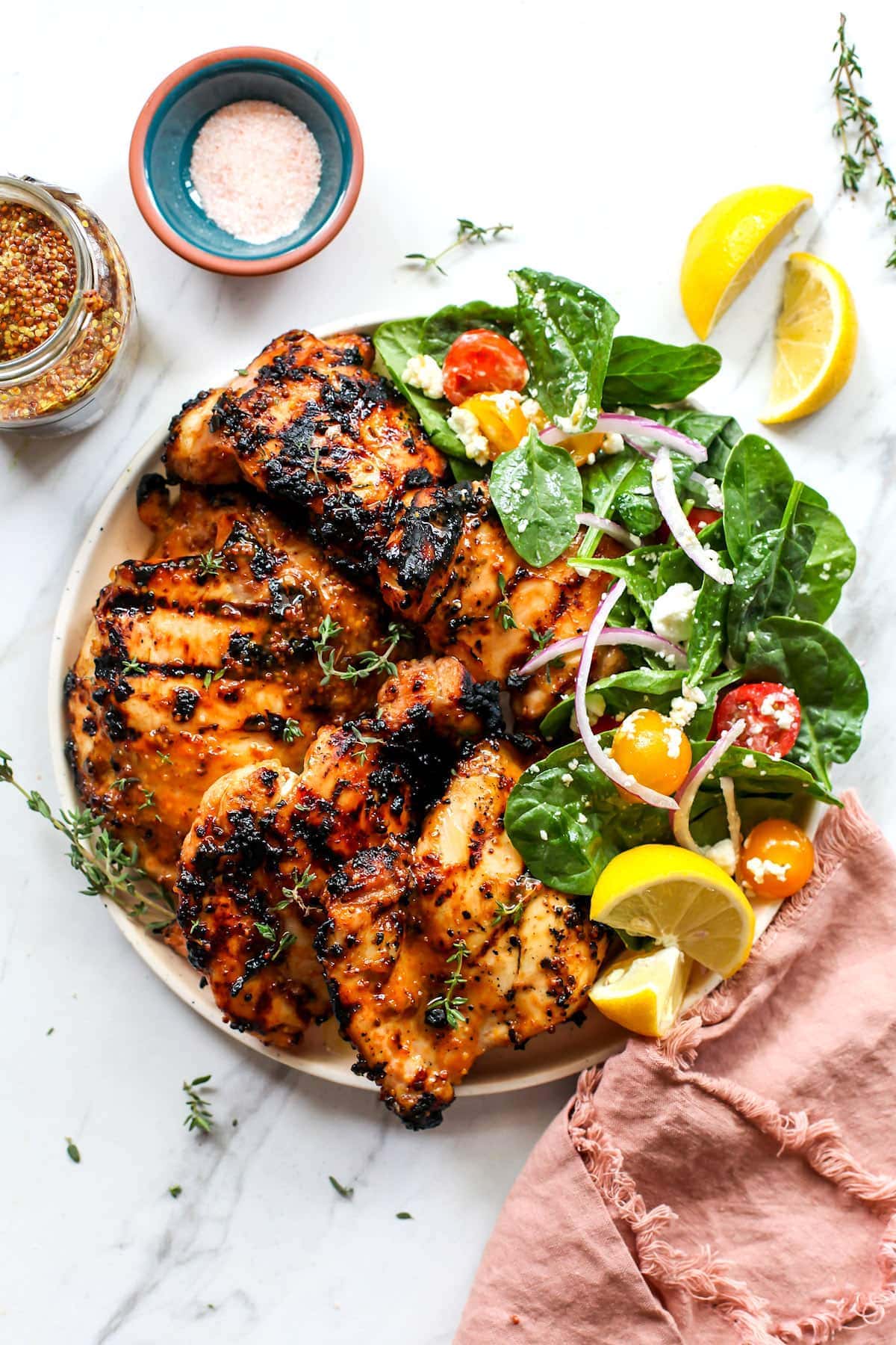 Honey mustard chicken on plate with salad.