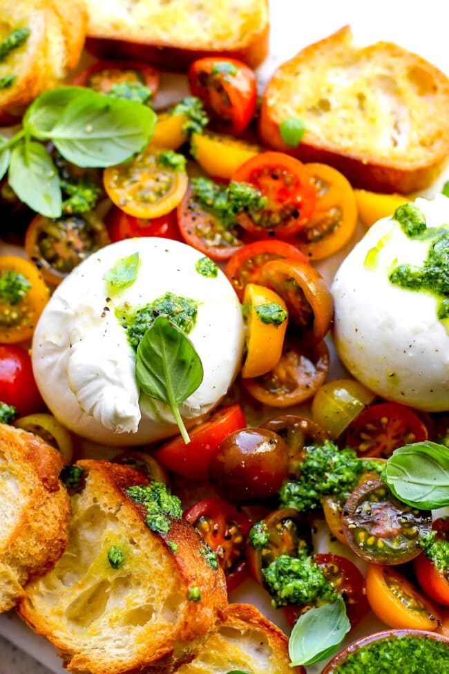 burrata with tomatoes, pesto, and grilled bread appetizer