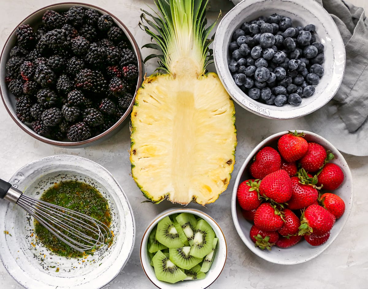 Fruit salad ingredients in bowls.
