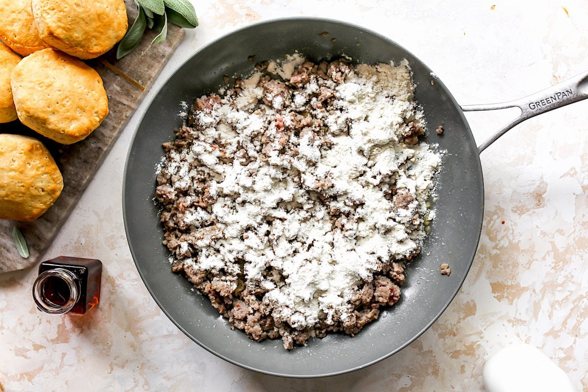 sausage in skillet with flour to make biscuits and gravy.