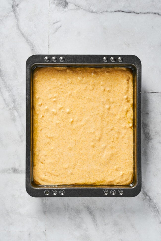 This easy cornbread recipe is tender, moist, perfectly sweet, and takes only 35 minutes to make, making it a wonderful side dish A baking dish filled with uncooked cornbread batter
