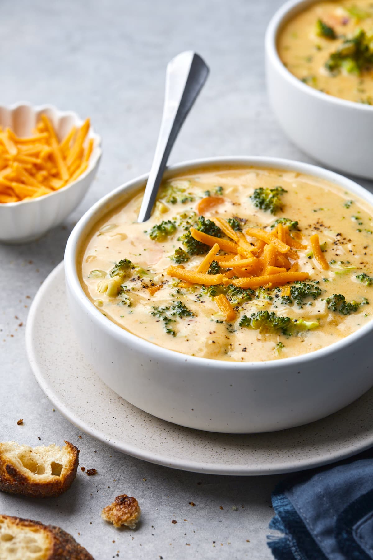 broccoli cheese soup in bowl with spoon.