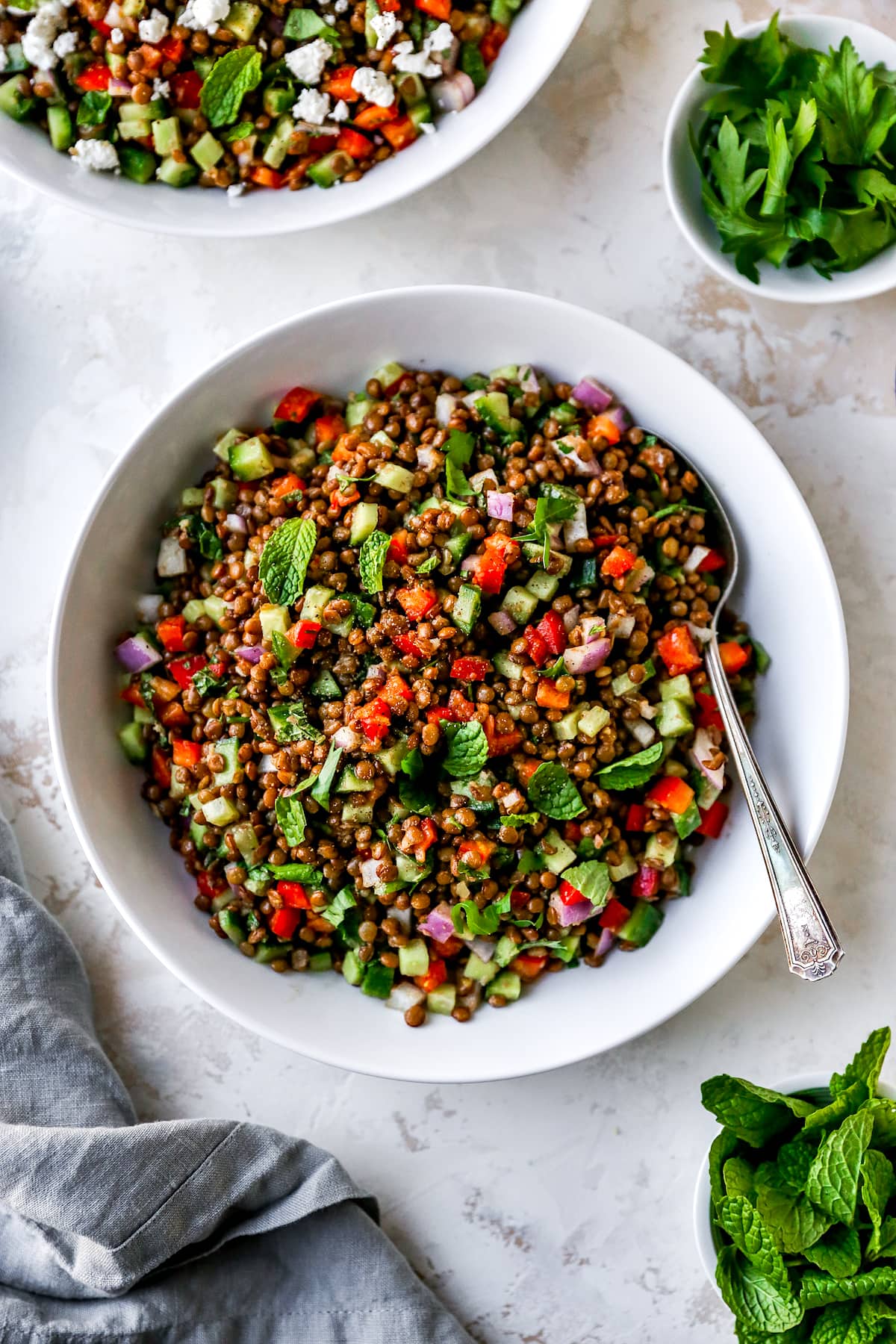 lentil salad in bowl with spoon.