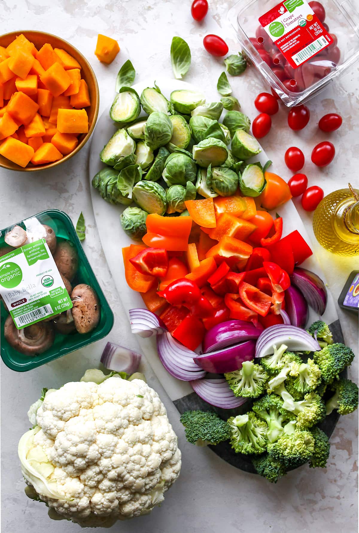 cutting up vegetables on a cutting board to make roasted vegetables.