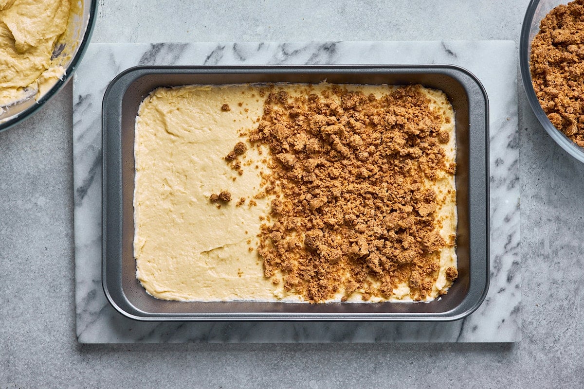 sour cream coffee cake batter in pan with cinnamon streusel topping.