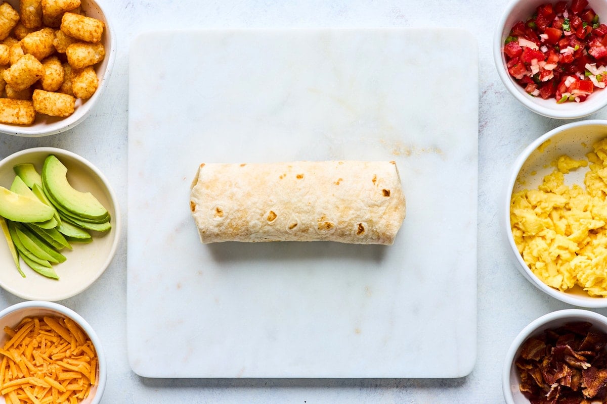 breakfast burrito rolled up in flour tortilla.