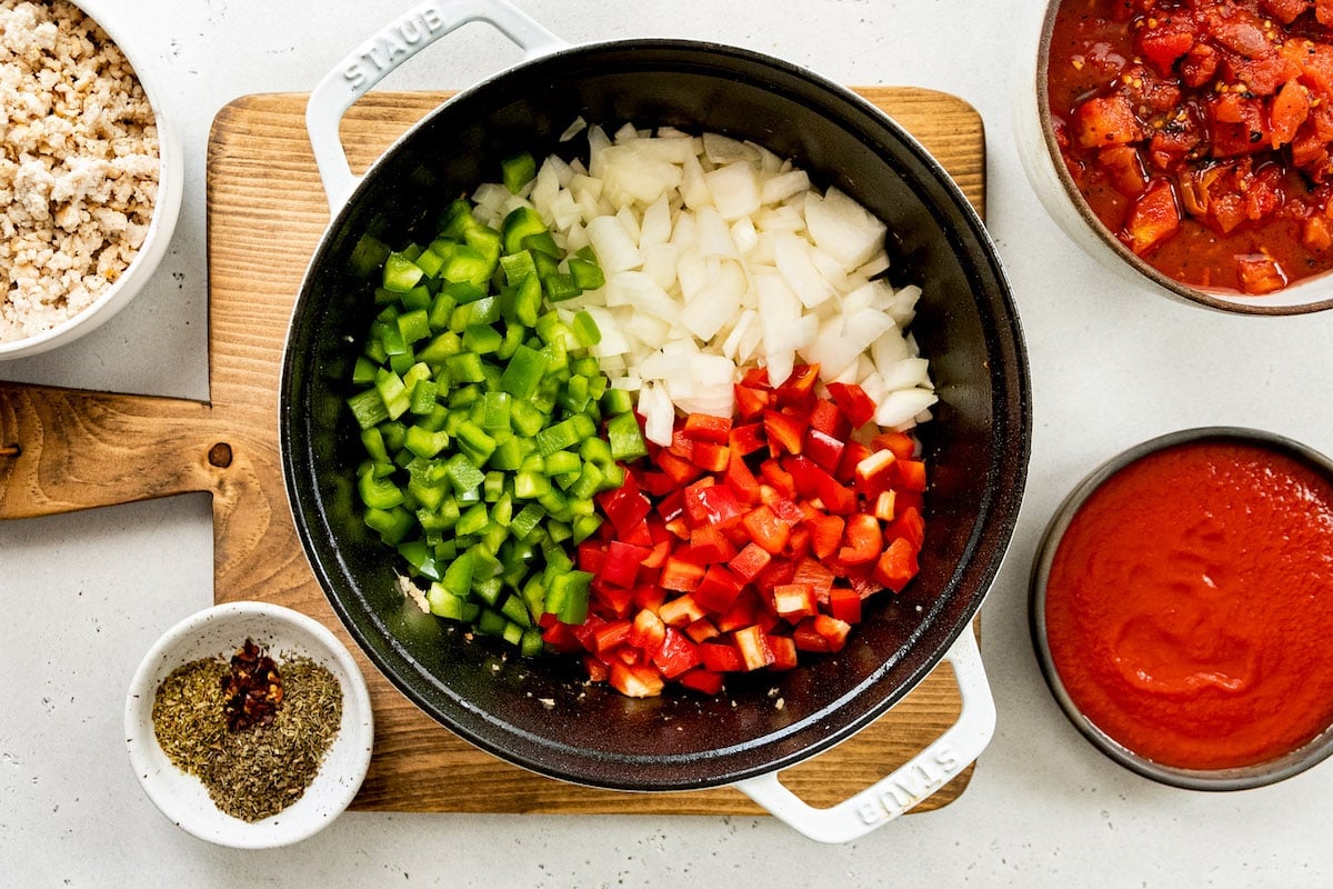 peppers and onion in pot to make stuffed pepper soup.