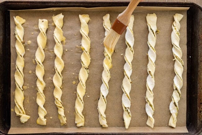 pesto parmesan cheese straws on baking sheet