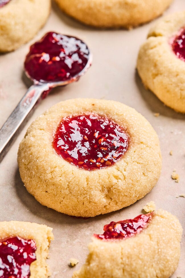 thumbprint cookie with raspberry jam on a spoon.