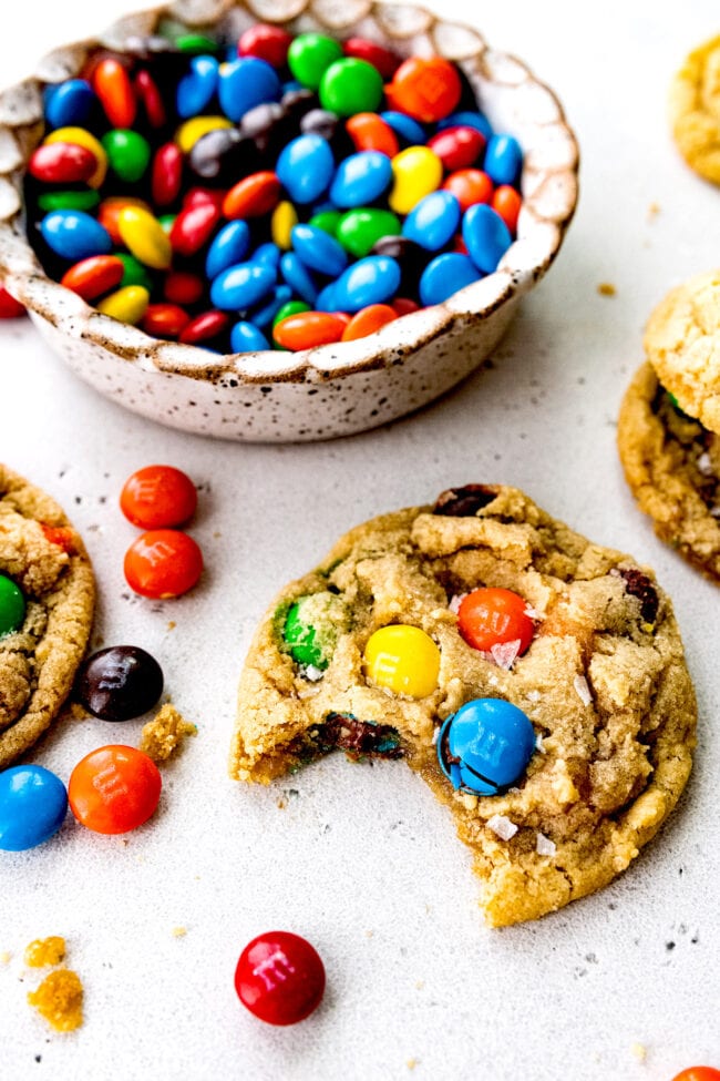 M&M cookie with a bowl of M&M's.