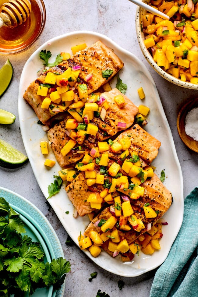 grilled salmon with mango peach salsa on platter.