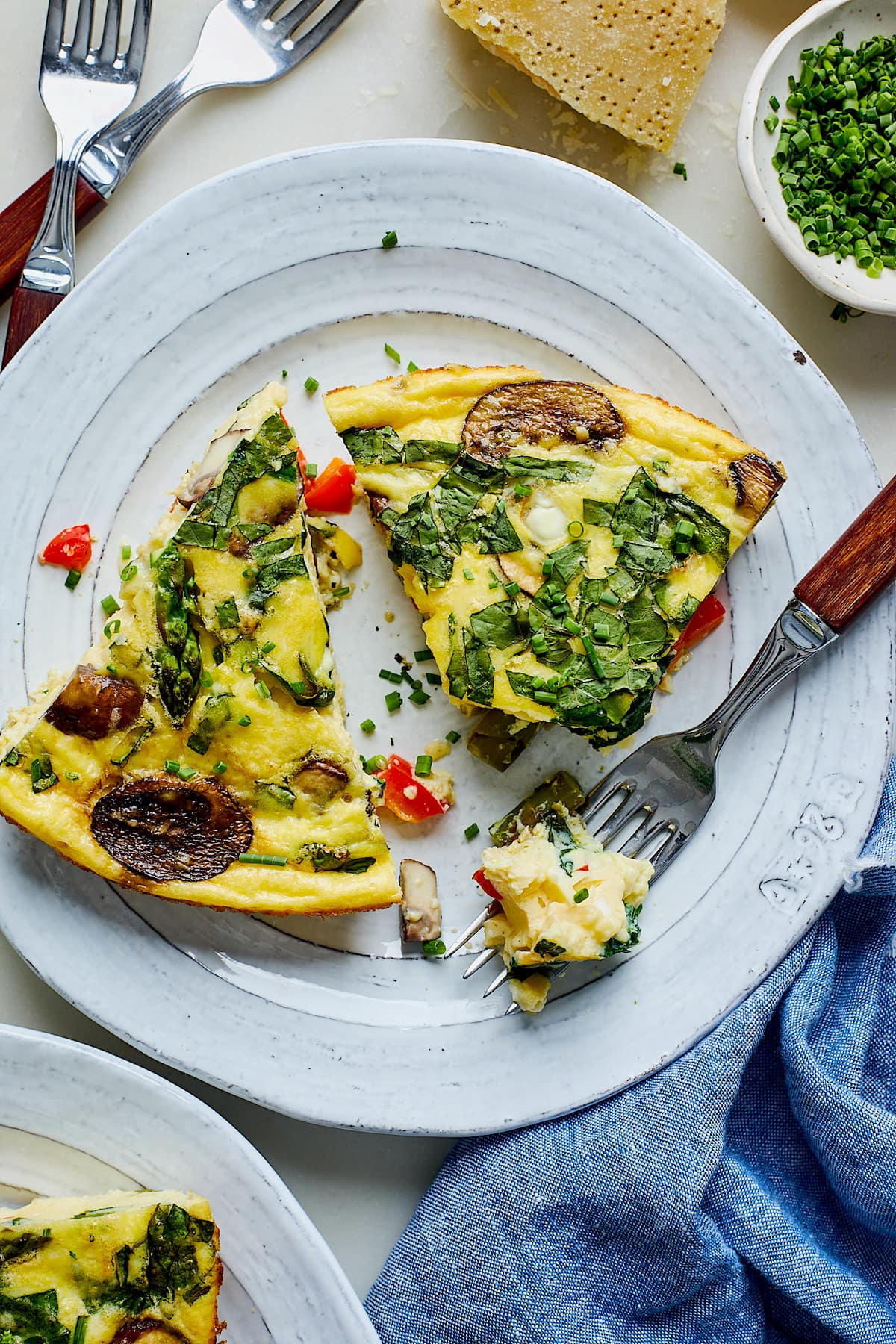 cottage cheese frittata cut in triangles on plate with fork.