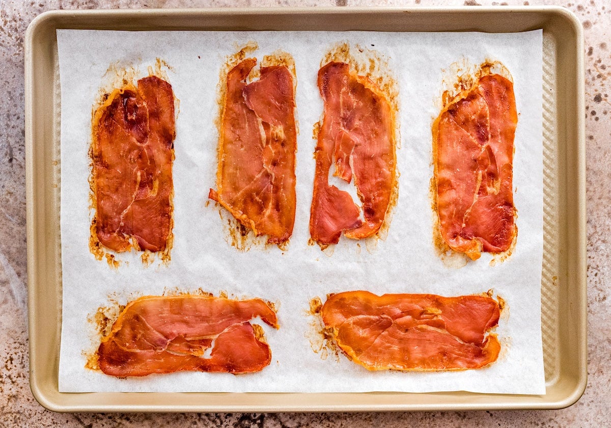 crispy prosciutto on a baking sheet with parchment paper.