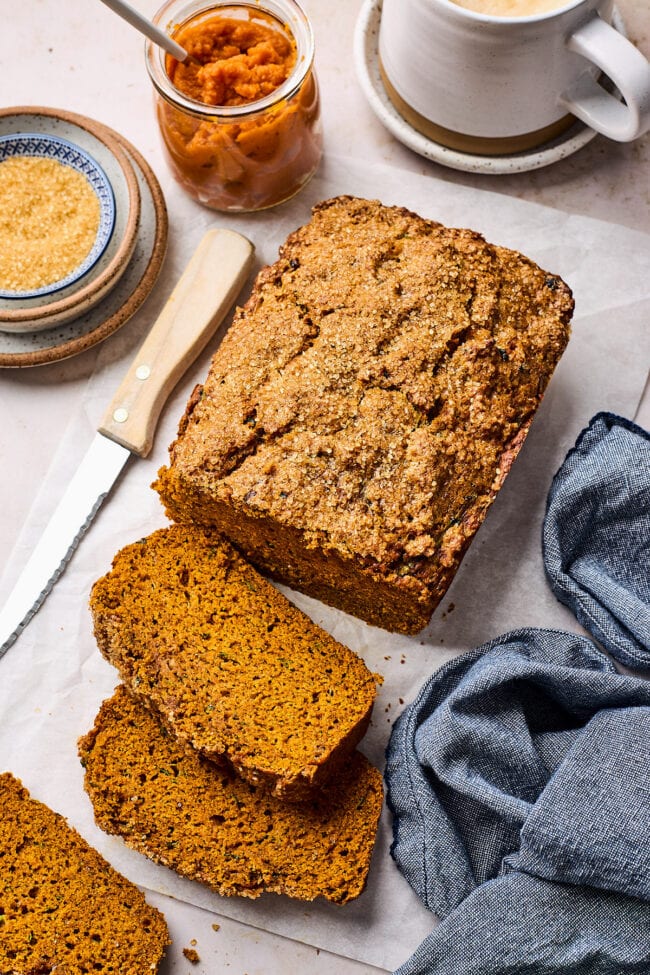 pumpkin zucchini bread cut in slices with knife.