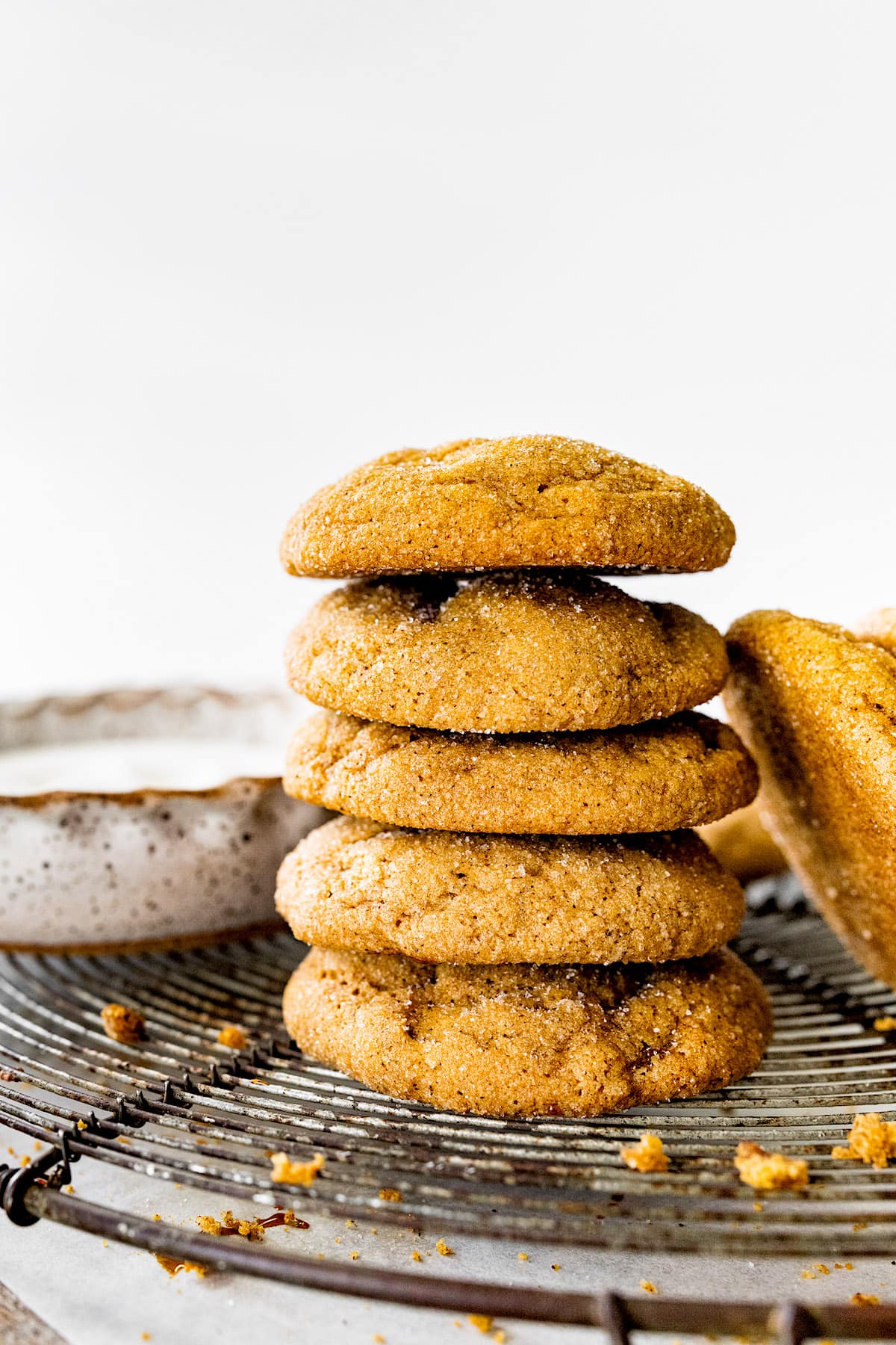 stack of pumpkin gingersnap cookies on cooling rack.