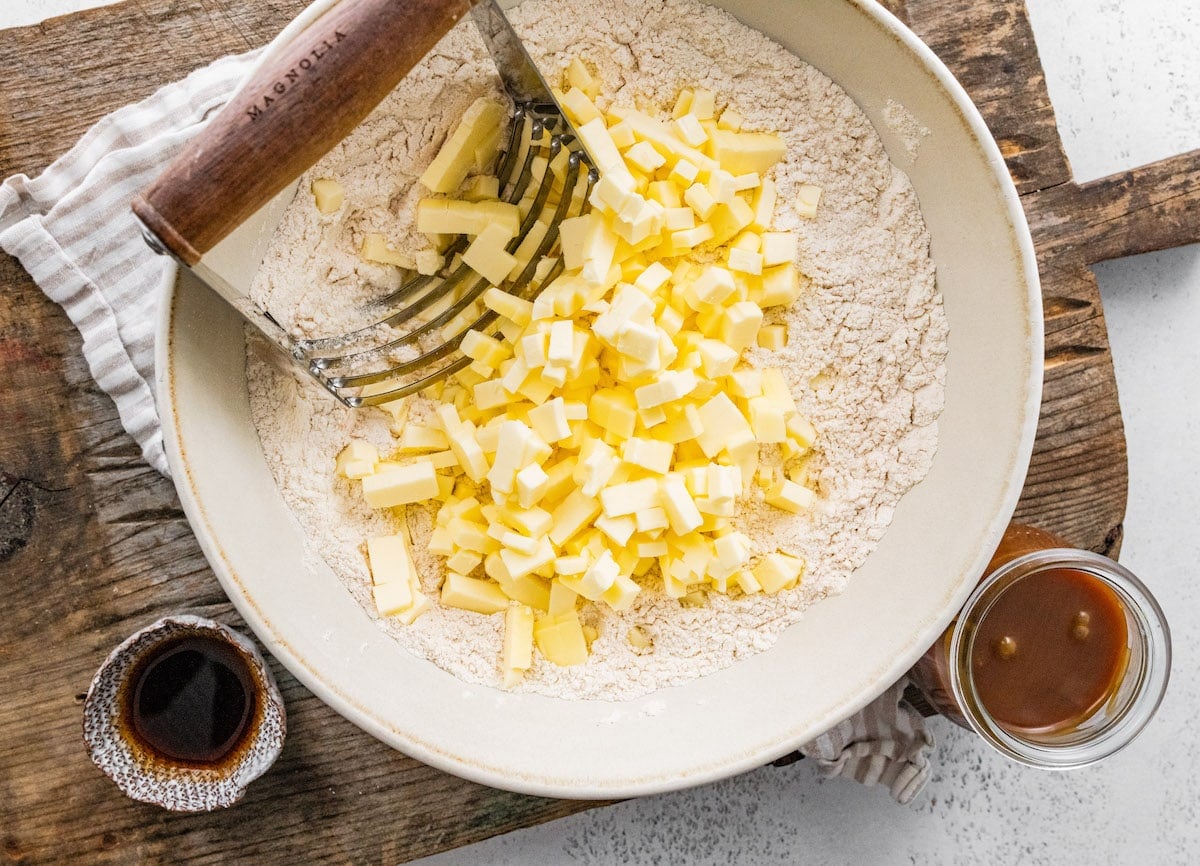 butter cut in cubes with flour in a large bowl with pastry cutter.