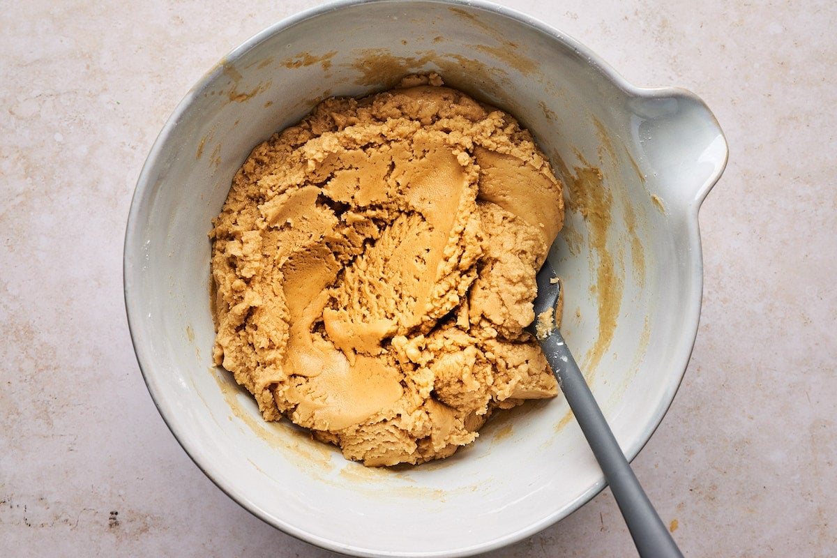 peanut butter fudge mixture in bowl with spatula.