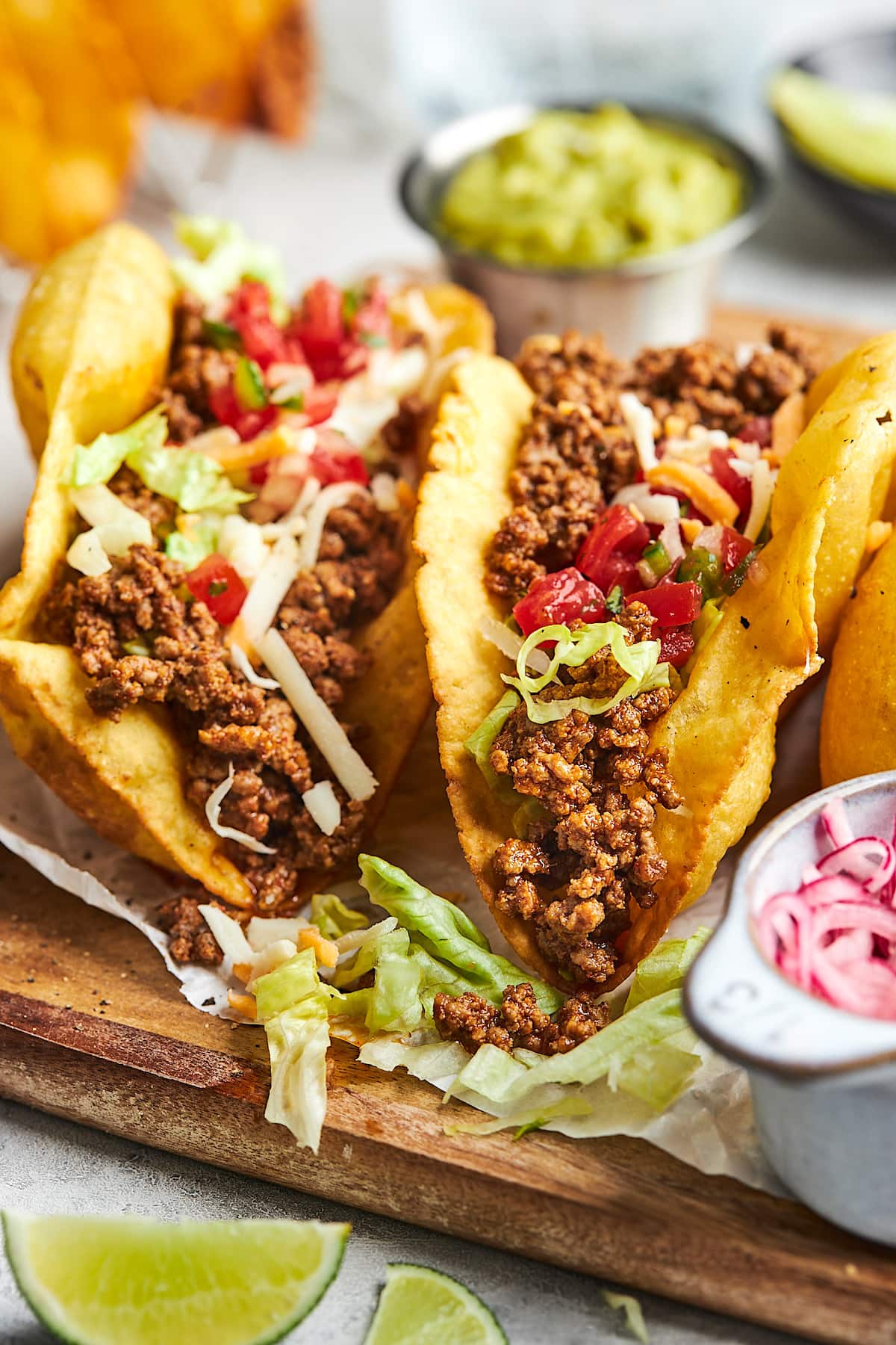 ground beef tacos in crispy taco shells with lettuce, tomato, and cheese.