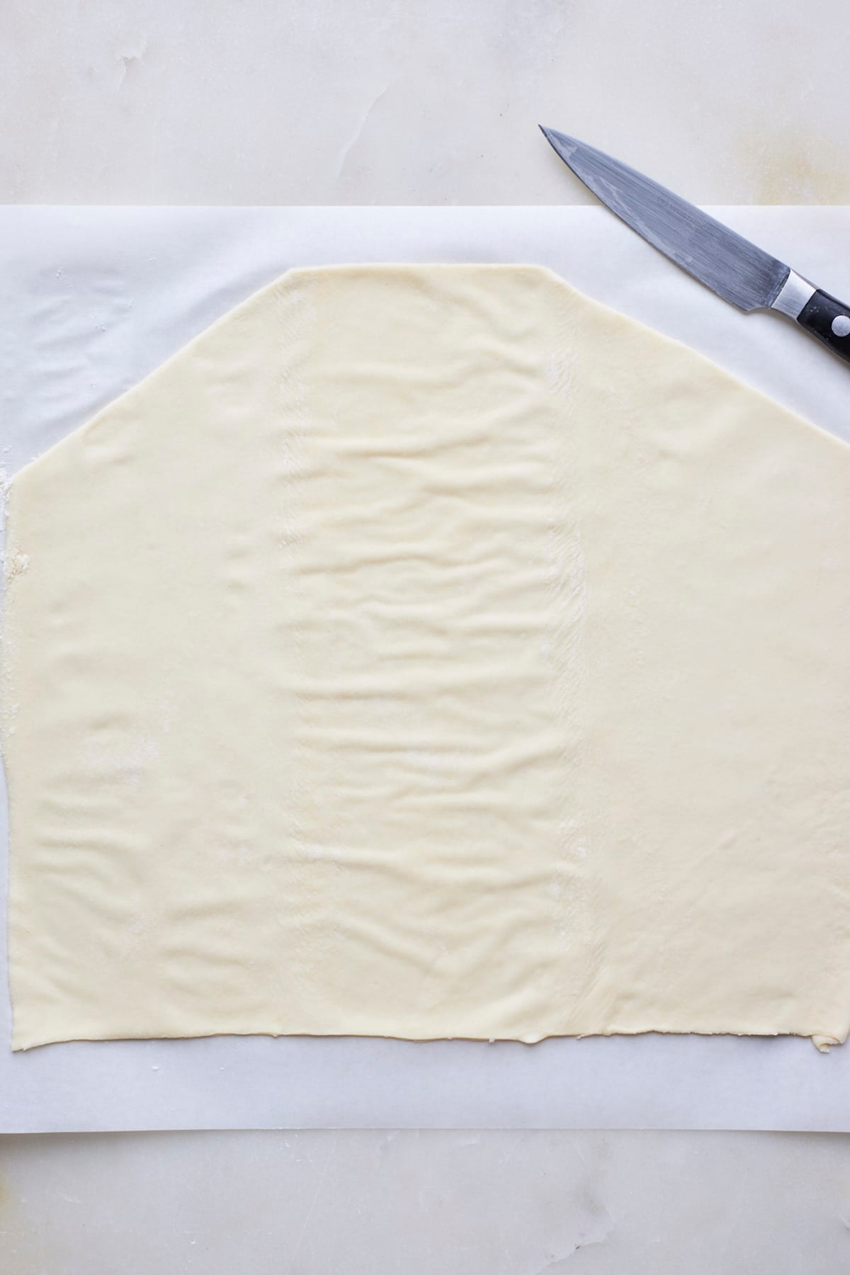puff pastry sheet rolled out and cut with a knife to make a breakfast bread.