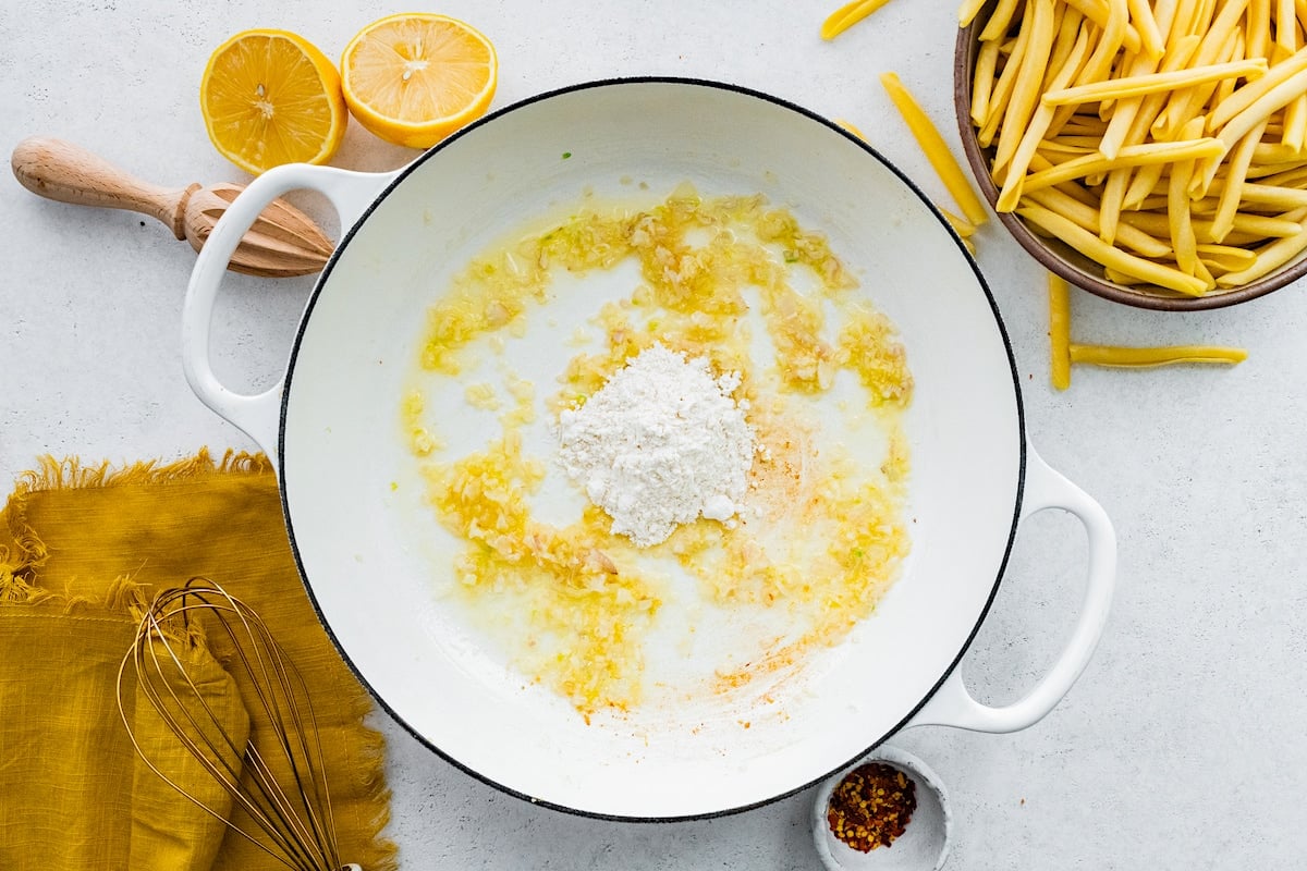 butter, shallot, garlic, and flour in white skillet.