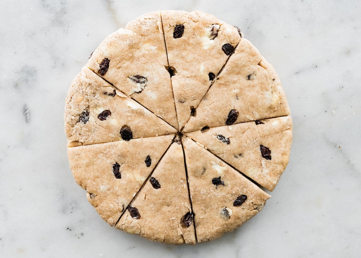 cinnamon raisin scone dough rolled into a circle and cut into 8 triangles.