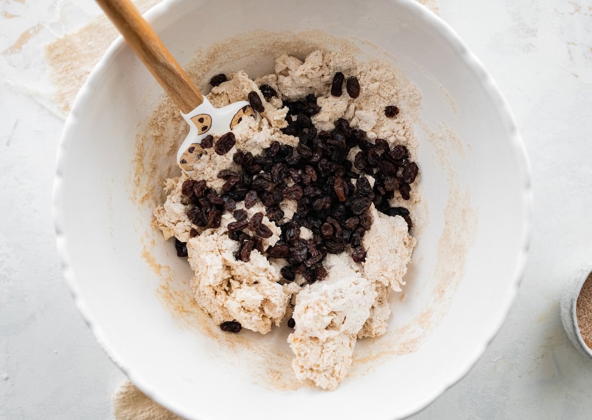 cinnamon raisin scone dough in mixing bowl with spatula.
