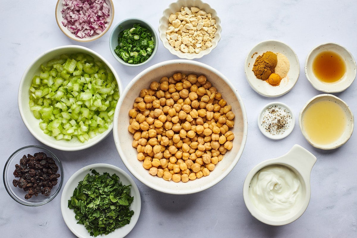 curried chickpea salad ingredients in bowls.