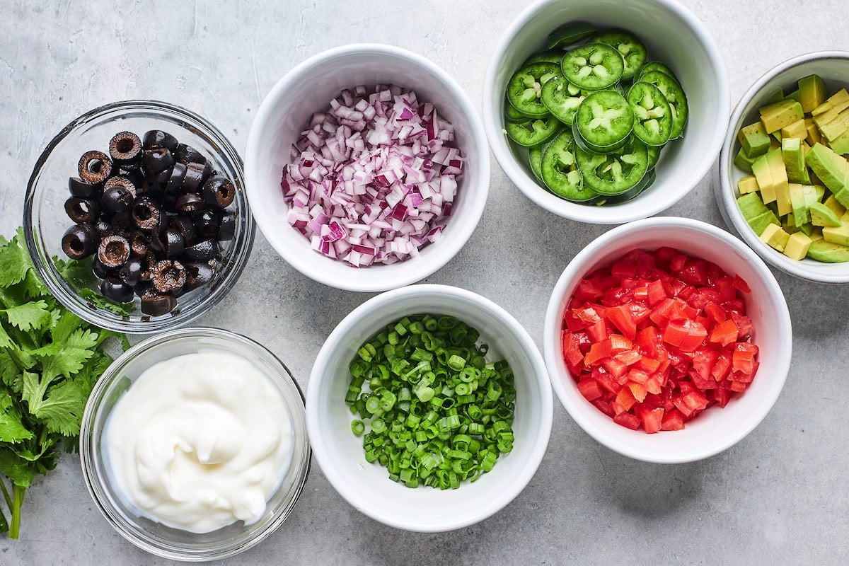 toppings in bowls for nachos.