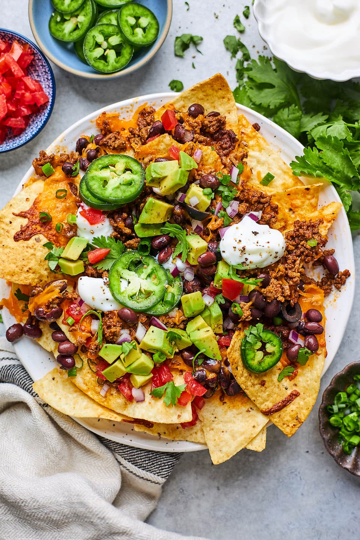 plate of nachos with toppings.