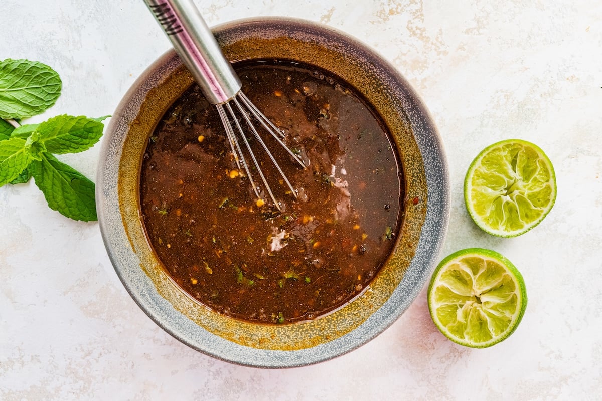 sauce for lettuce wraps in bowl with whisk.