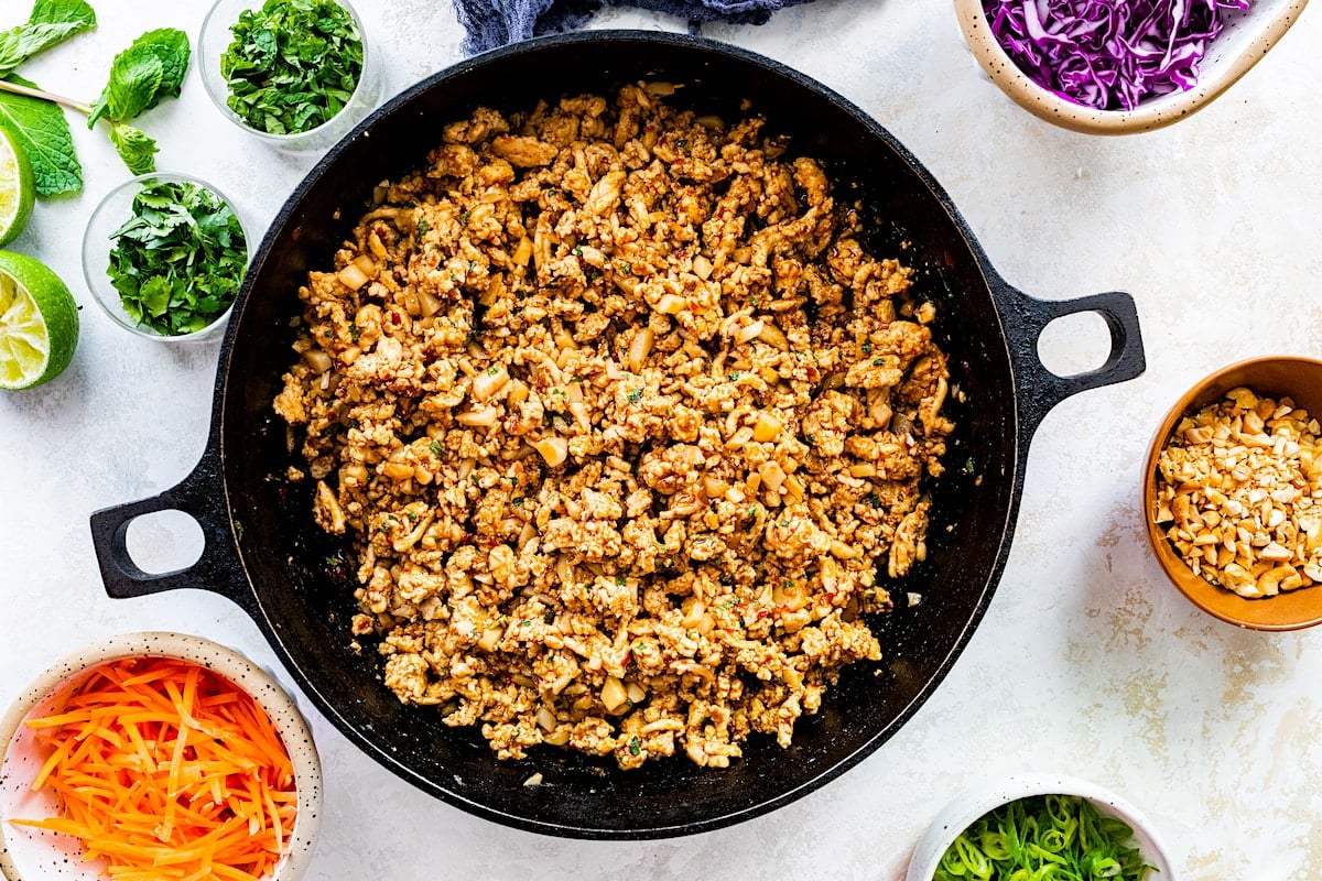 ground chicken lettuce wrap filling being cooked in skillet.