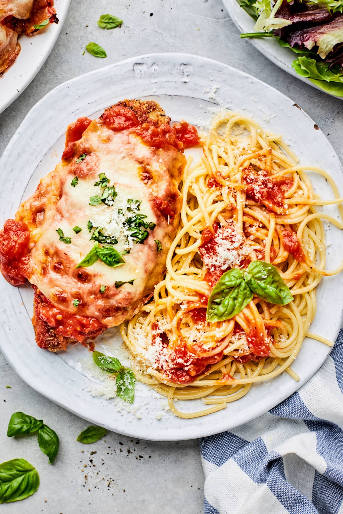chicken parmesan on plate with spaghetti.