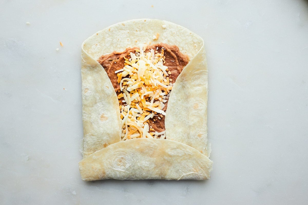 rolling up a bean and cheese burrito.
