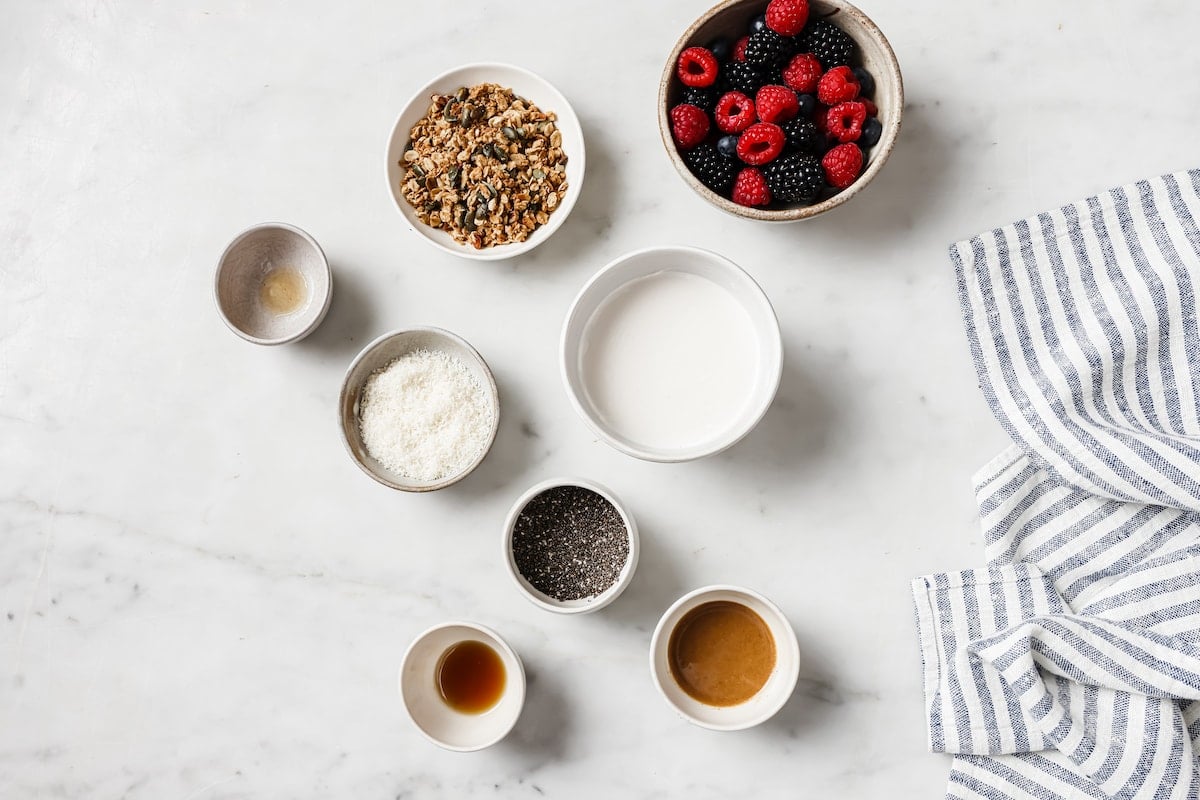 chia pudding ingredients in bowls with tea towel.