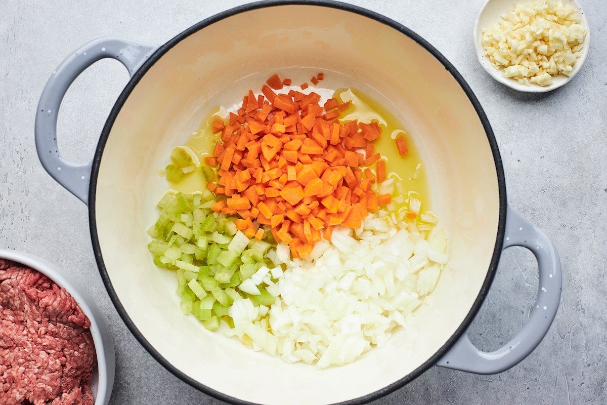 onion, celery, and carrot cooking in olive oil in a big pot.