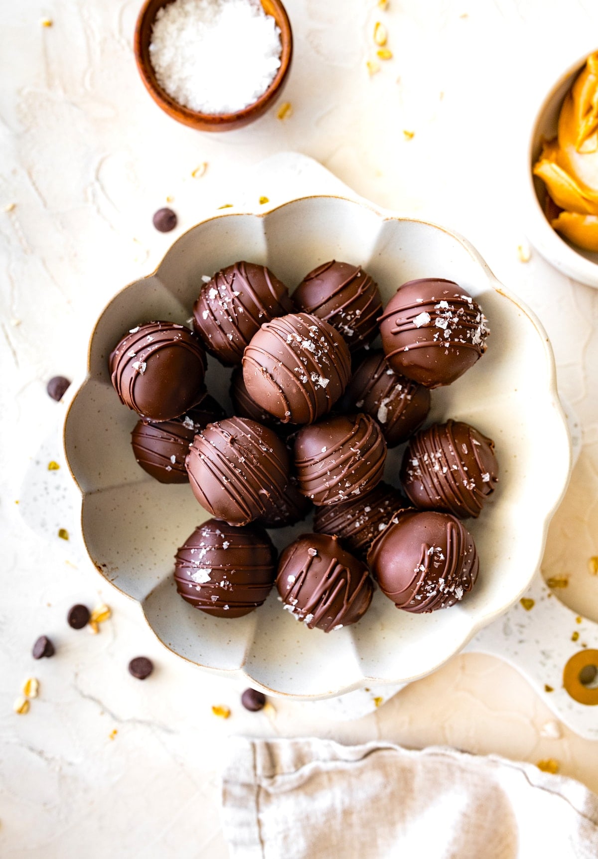 peanut butter protein balls dipped in chocolate on plate.