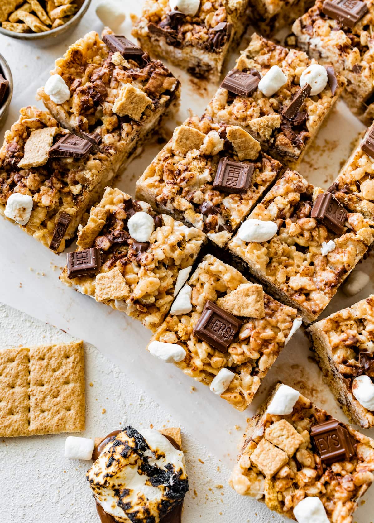s'mores rice krisipe treats cut in squares with graham crackers and Hershey's chocolate bars.