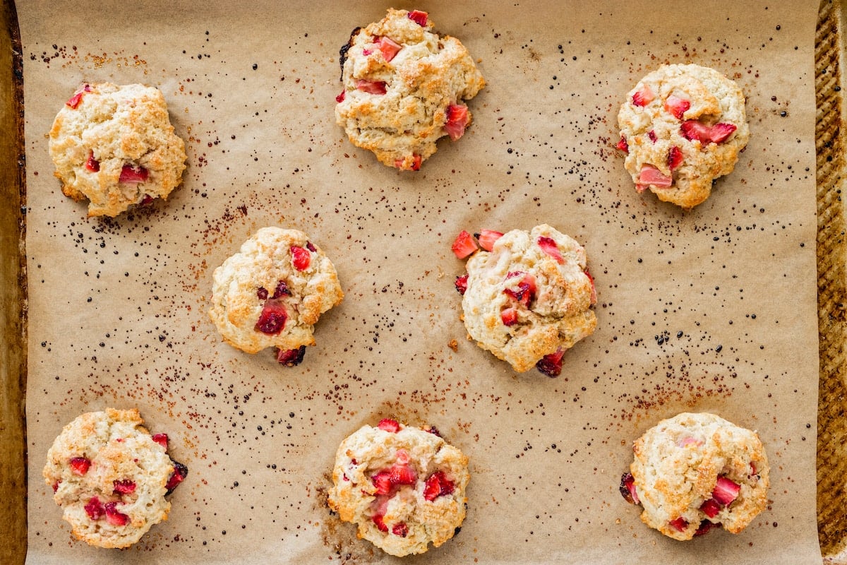 strawberry biscuits on baking sheet with parchment paper.