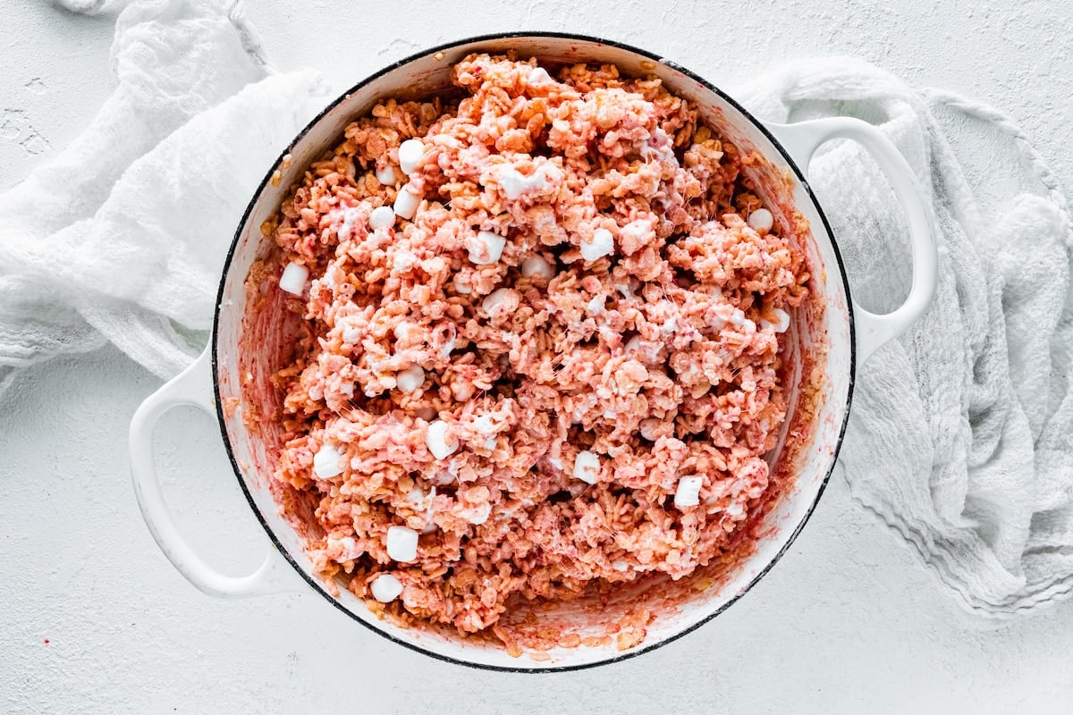 strawberry rice krispies with mini marshmallows in white pot.