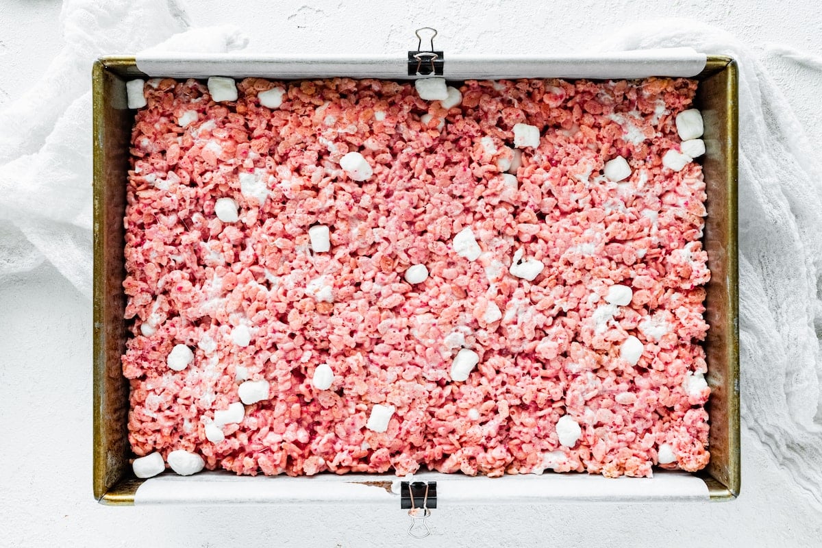 strawberry rice krispie treats pressed into pan.