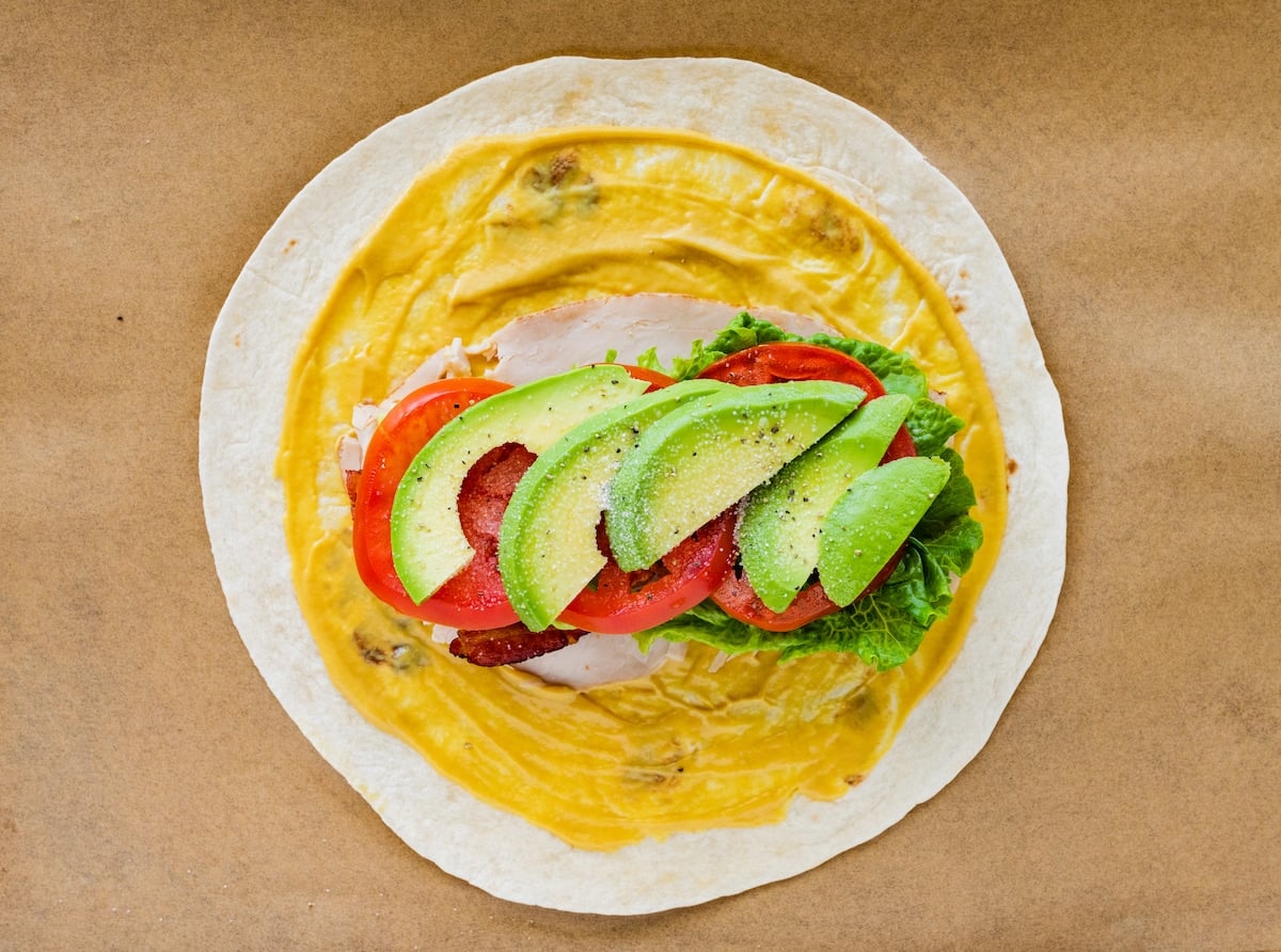 tortilla with honey mustard, turkey, lettuce, tomato, avocado, and bacon.