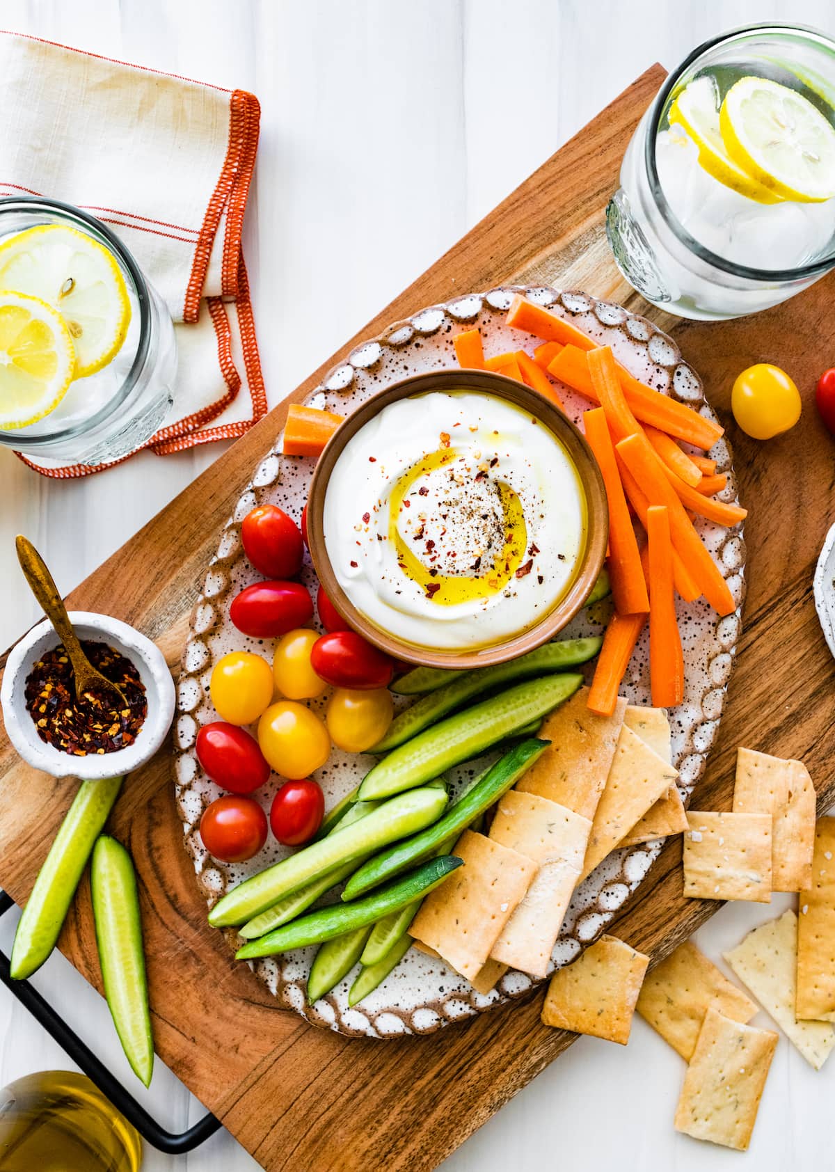 whipped cottage cheese in bowl on platter with veggies and crackers.