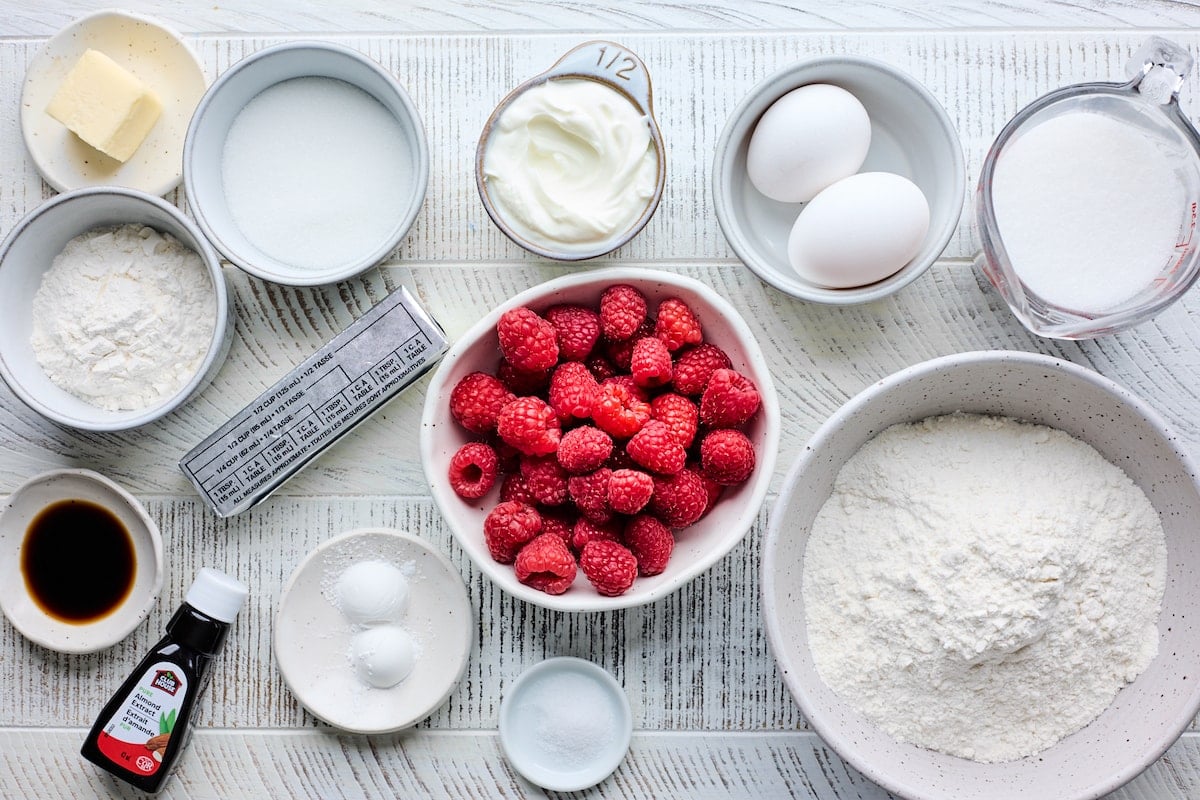 ingredients in bowls to make raspberry muffins.
